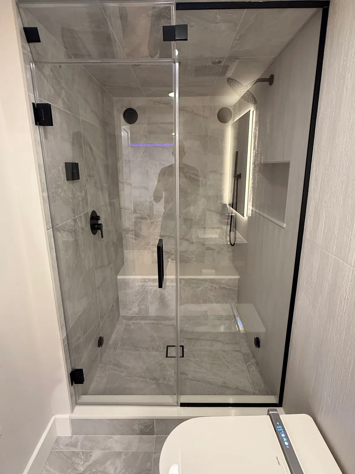Basement steam shower with frameless glass doors