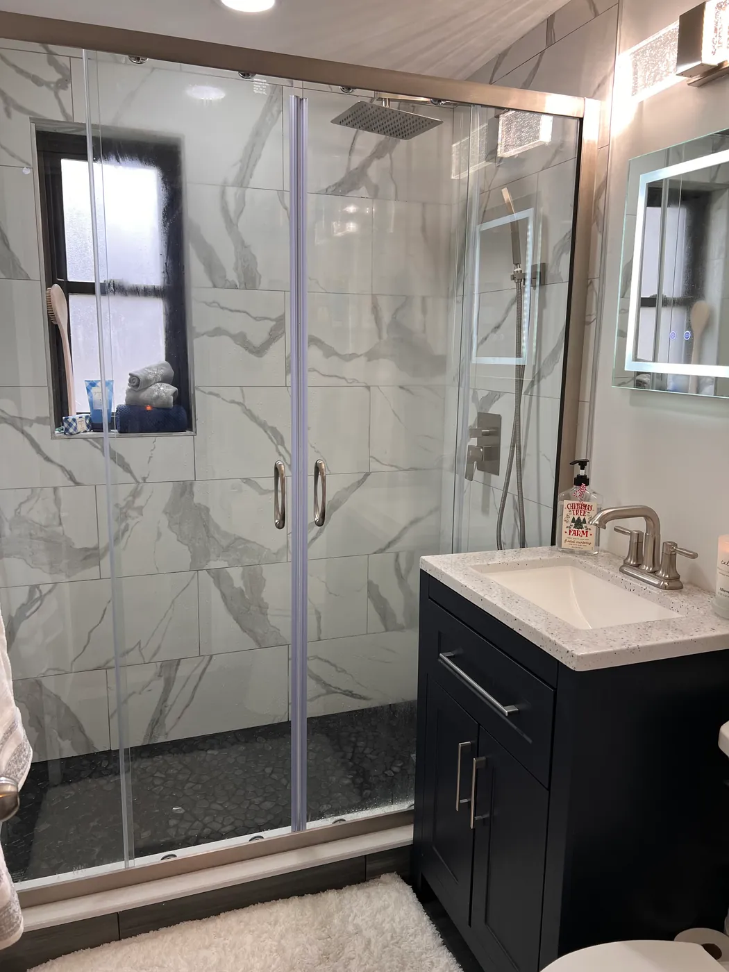 Small remodeled bathroom with a sliding glass shower door