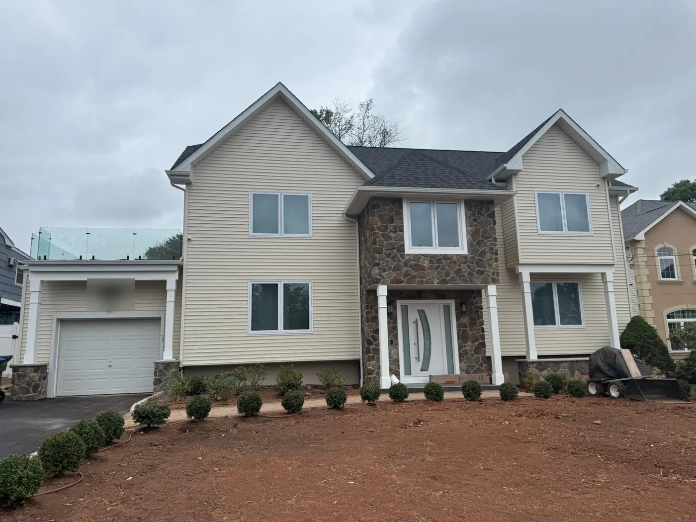 Two-story house with a stone-veneer entry after a complete second floor was added over a former ranch