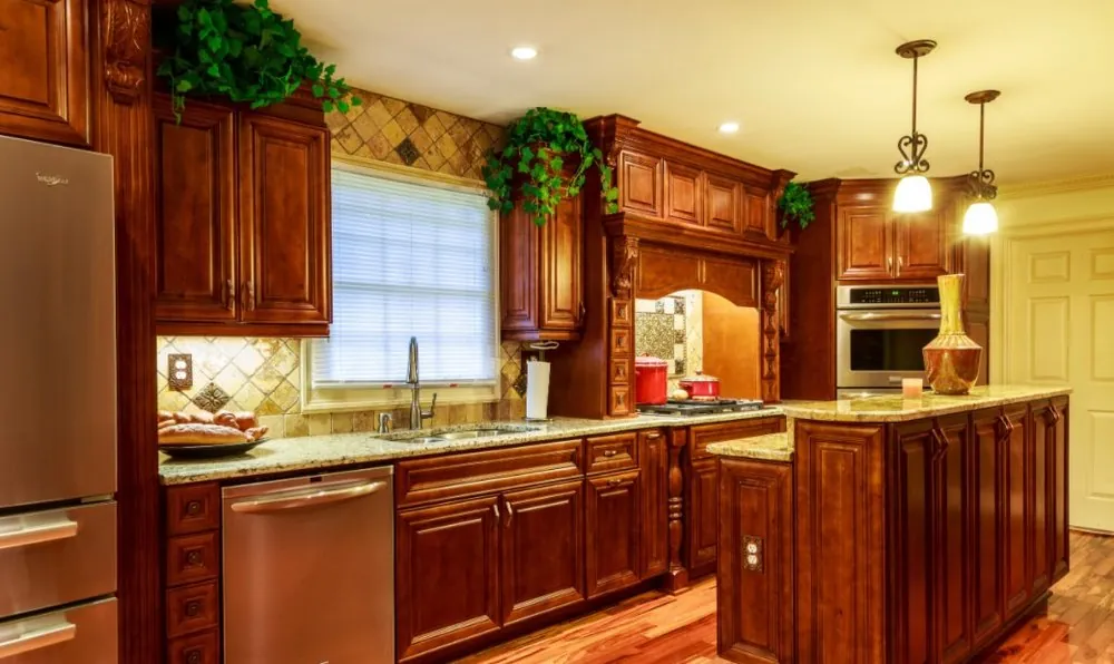 Traditional kitchen with cherry raised-panel cabinets, granite counters, diamond tile backsplash, wall oven and island.