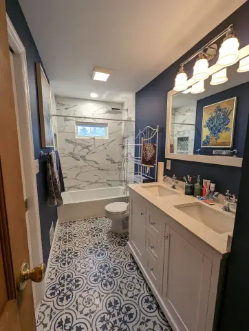 Bathroom with double vanity and patterned tile