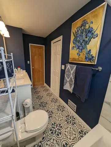 Bathroom with patterned floor and navy walls