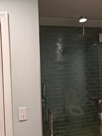 Green tile shower with glass