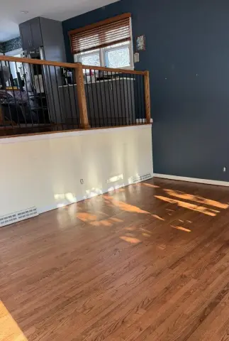 Refinished hardwood floors with black balusters