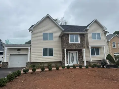 Second-floor addition with stone front exterior