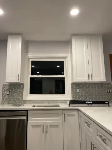White shaker kitchen with mosaic backsplash